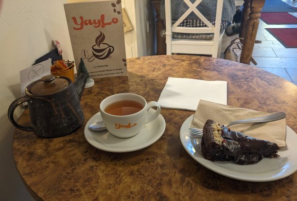 Photo of teapot, tea in cup and saucer and Nutella cake at Yaylo cafe.